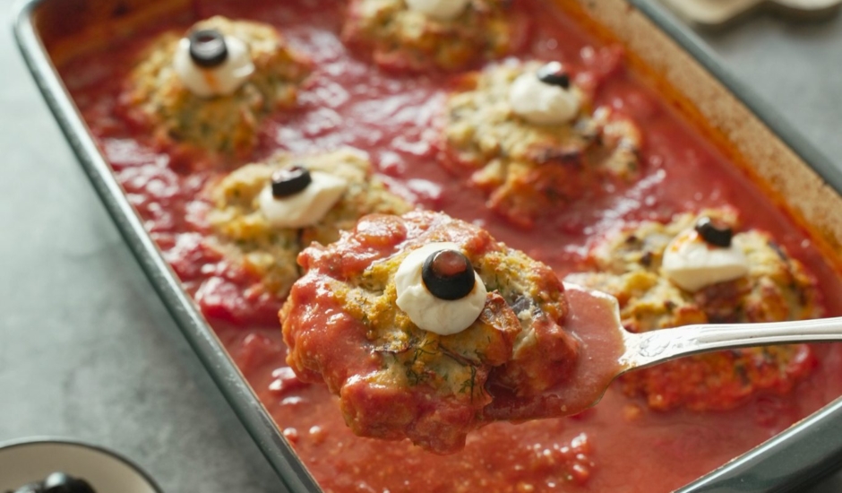 a baked fishball topped with mozzerella and olive to make a fish eyeball on a spoon