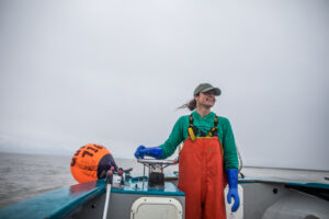 Salmon harvester driving boat smiles in Prince William Sound, Alaska