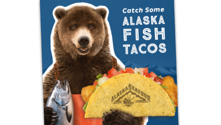 bear holding fish taco