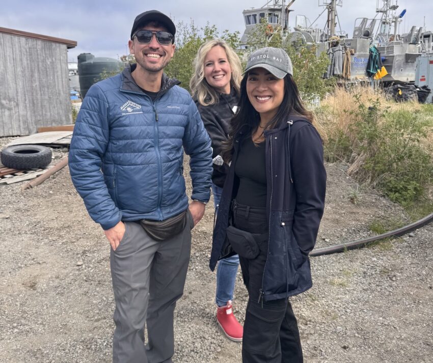A man and two women pose for a photo.