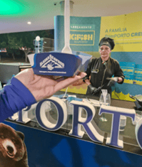 A hand holding a blue cup with the alaska seafood logo on it