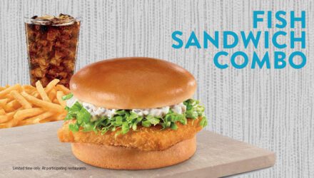 fried fish sandwich sitting on table near cola with words fish sandwich combo nearby