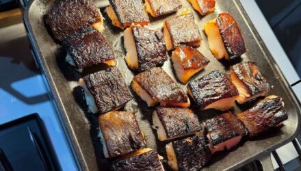 A tray of cooked miso marinated black cod fillets.