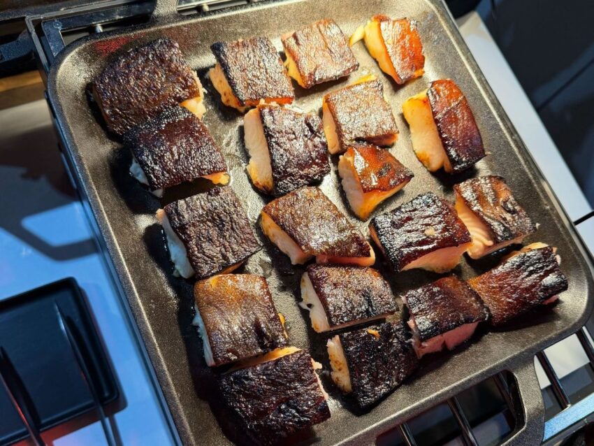 A tray of cooked miso marinated black cod fillets.